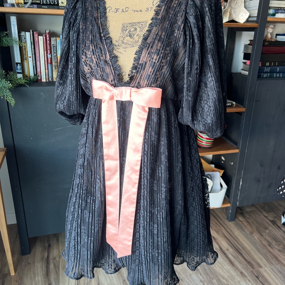 Urban Outfitters Kimchi Blue black lace babydoll mini dress with a pink bow.